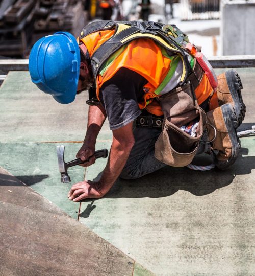 man-wearing-blue-hard-hat-using-hammer-544966